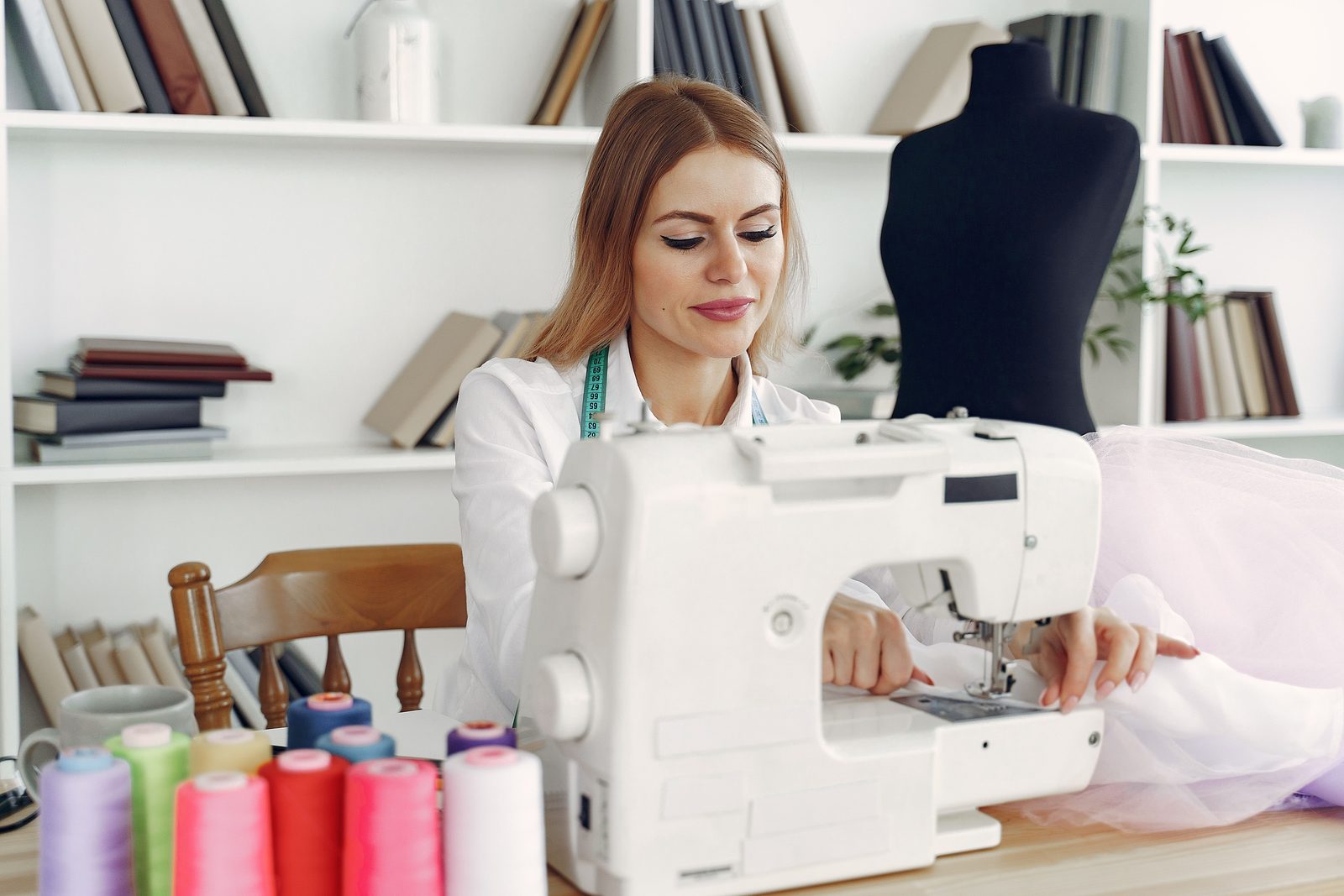 Fashion designer sewing in a studio